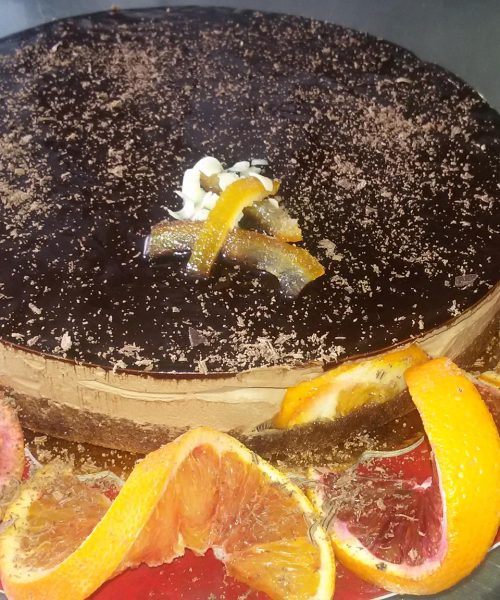 Torta al cioccolato decorata con fette d'arancia.